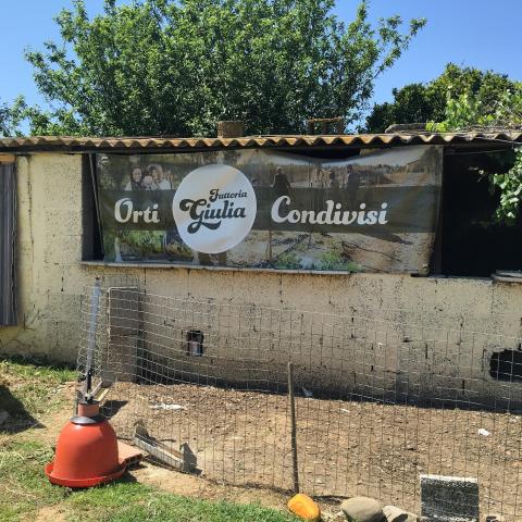 Photo of the sign of the community gardens at Giulia's Farm