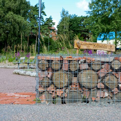 A so called gabion wall, with recycles materials such as bricks, rock and wood are placed in a metal net.