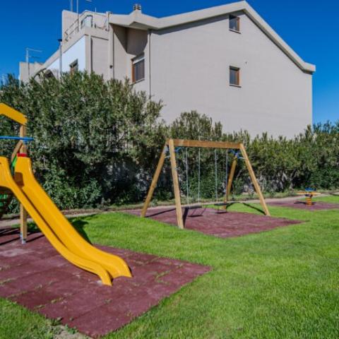 Park for children with slide and a pair of swings