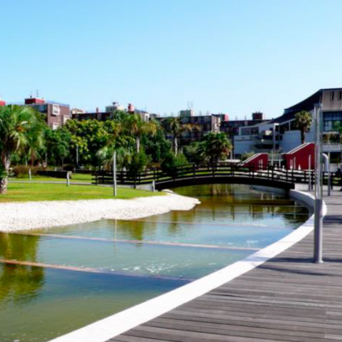 Photo of the park: green spaces, walking path, artificial river.